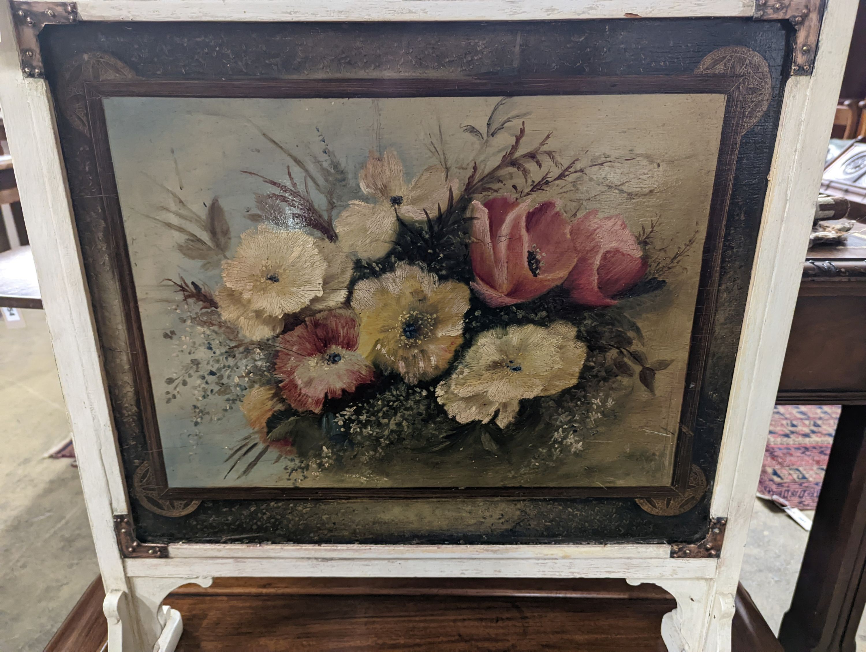 An Arts and Crafts painted copper mounted firescreen, width 64cm, height 78cm